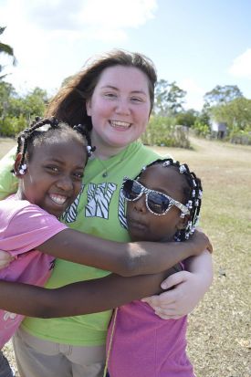 SMWC student Haylie Davenport with two young girls living in the Dominican Republic.