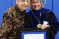 Dorthy Weinz Jerse stands with President King holding award