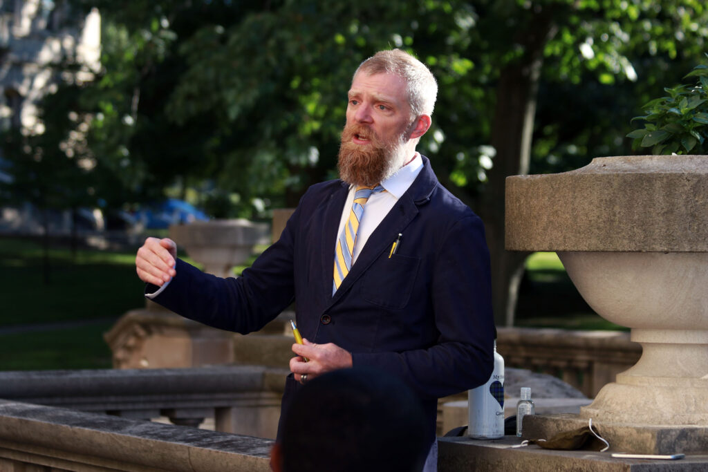 Josh MacIvor-Andersen, MFA, teaches an outdoor English class