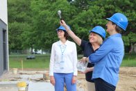 Leaders of the College bless the new dining center with holy water.